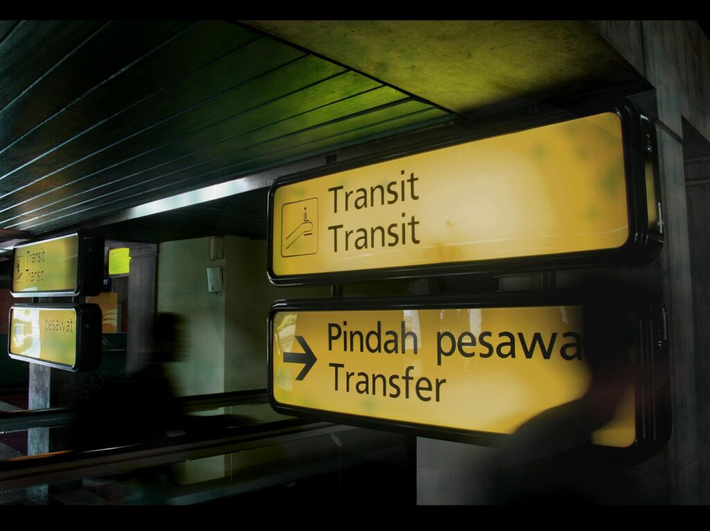 Illuminated transit signs at an airport in Banten, Indonesia, guiding passengers.